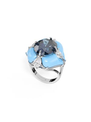 Just Brilliant White gold ring with large oval deep blue lab grown sapphire center stone, surrounded by lab created diamond accents in a sculptural design on white background