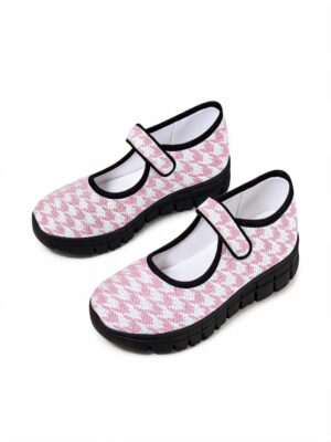 Rich and Rich Pink Houndstooth Women’s Mary Jane’s with pink and white patterned upper, black trim, Velcro strap, and black EVA sole.