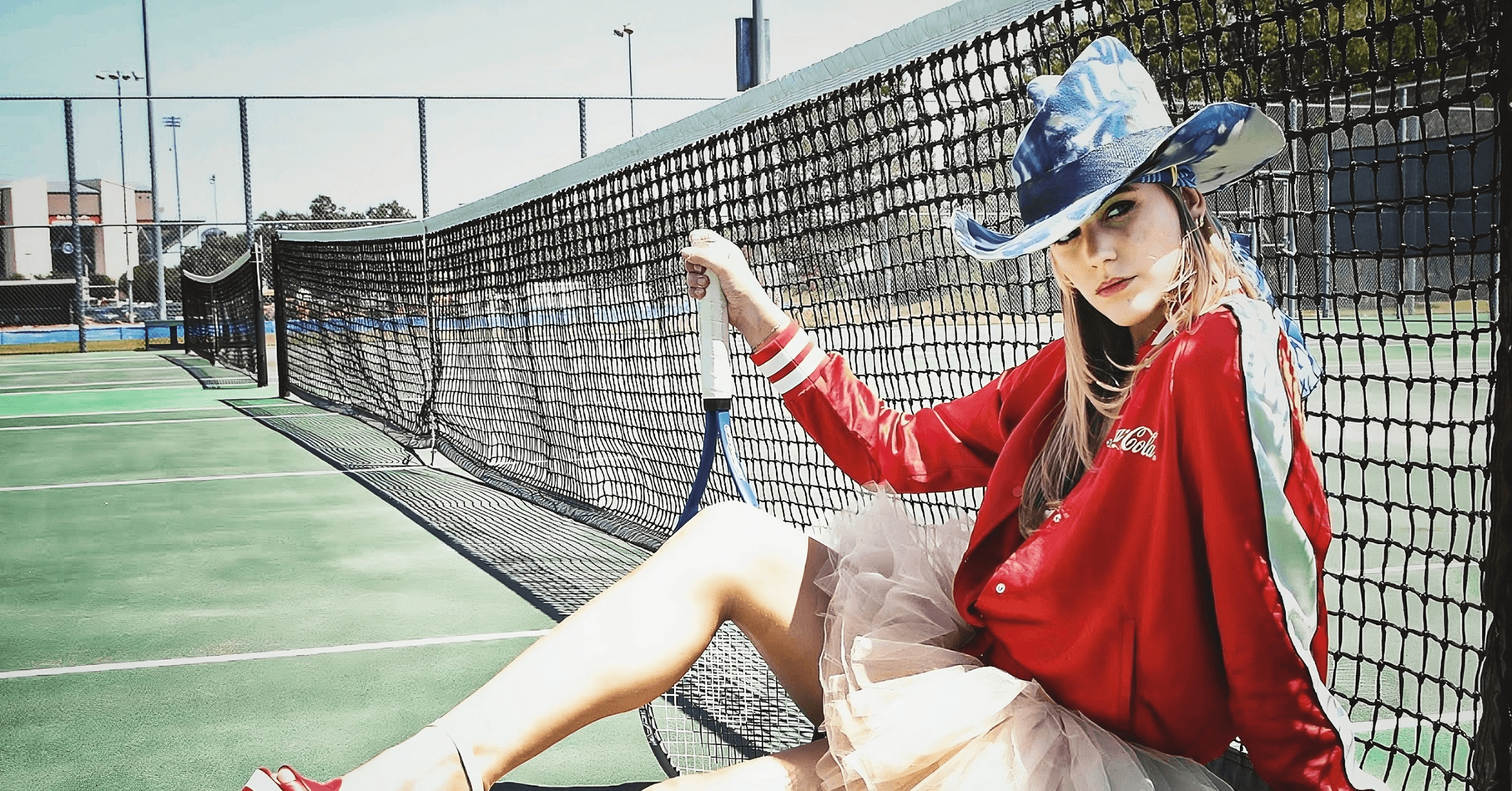 Girl posing with the Rosa Isela Blue Hat from Flying Solo NYC