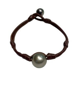 Bracelet featuring a single round Tahitian pearl set on a hand-rolled leather band.