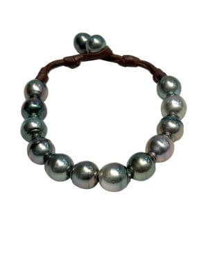 Bracelet with twelve 11 mm Tahitian pearls mounted on a hand-rolled leather band.