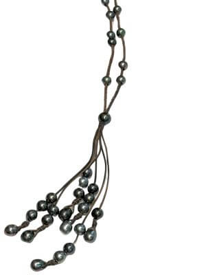 Braided leather necklace featuring 33 natural Tahitian pearls in varied hues — peacock, silver, aubergine and deep black.