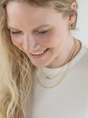 Gold-plated sterling silver fine chain necklace with green peridot crystal pendant, handcrafted from recycled materials, symbolizing growth, renewal, and fresh energy