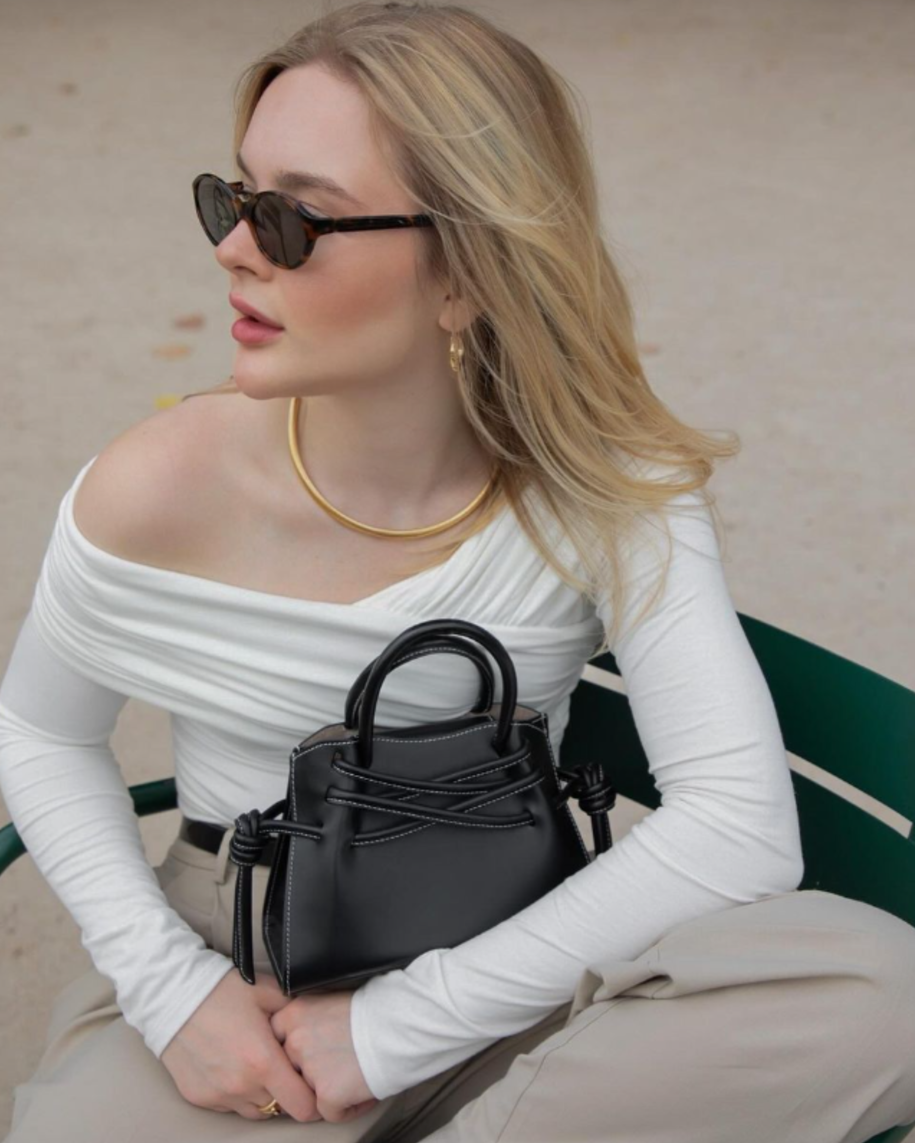 Blonde woman wearing black sunglasses matching with a Black Mini Tote Bag by FUNDAO