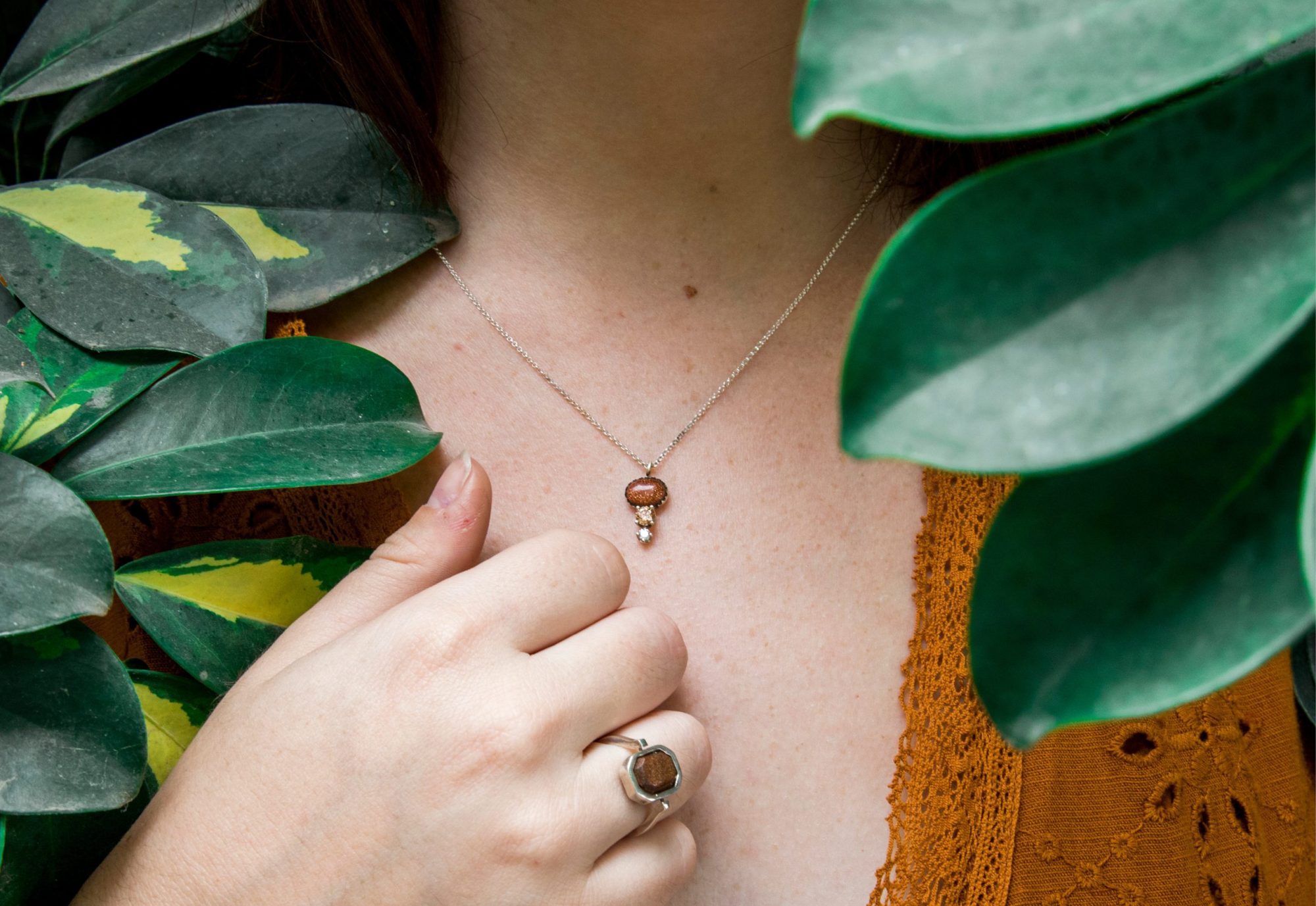 Model showcasing Madú fine silver jewelry, including a ring and necklace, available at Flying Solo NYC